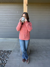Load image into Gallery viewer, Woman in a pink sweater and jeans drinking from a white mug outdoors.