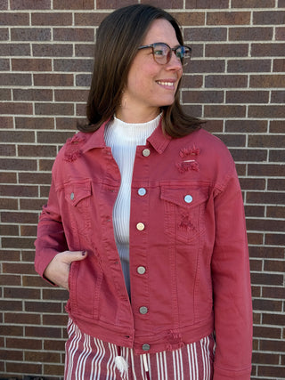 Woman wearing distressed red jacket.