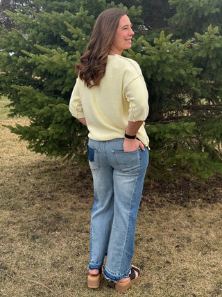Woman standing outdoors with trees in the background