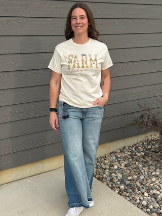 A woman wearing a Farm to feed America graphic tee.