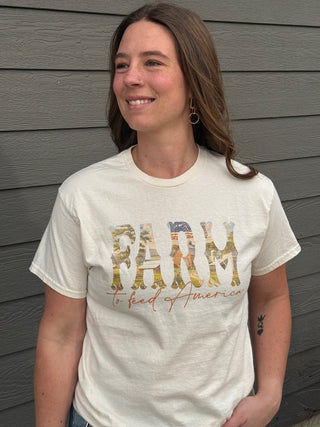 A woman wearing a Farm to feed America graphic tee.