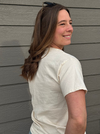 A woman wearing a Farm to feed America graphic tee.