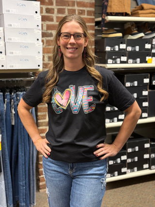 A lady wearing a LOVE graphic black t shirt.