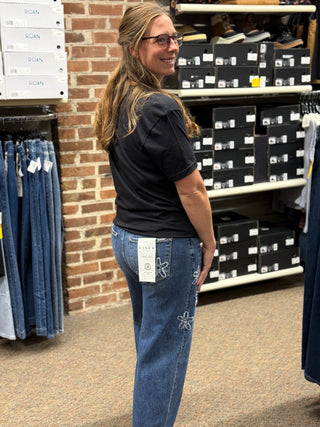 A lady wearing a LOVE graphic black t shirt.