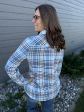 Load image into Gallery viewer, Woman wearing a blue plaid shirt standing against a gray wall.
