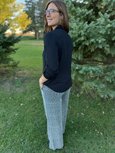 Load image into Gallery viewer, Woman standing outdoors in a grassy area with trees in the background
