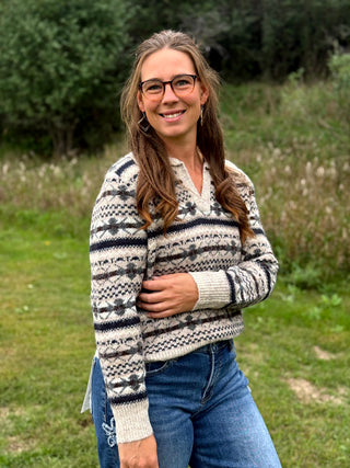 A lady wearing a johnny collar fair isle sweater.
