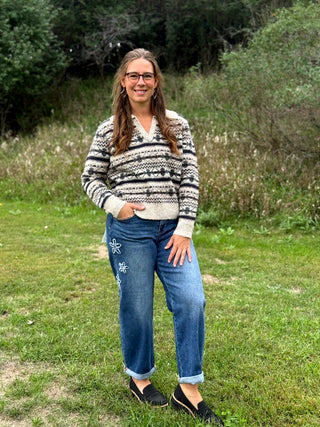 A lady wearing a johnny collar fair isle sweater.