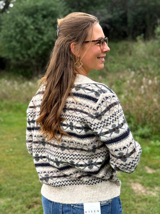 A lady wearing a johnny collar fair isle sweater.