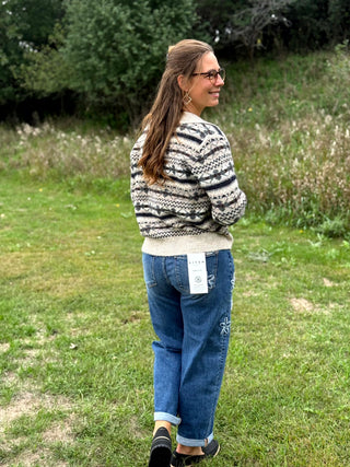 A lady wearing a johnny collar fair isle sweater.