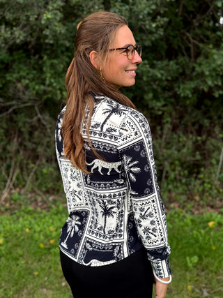 A lady wearing a black and white print blouse.