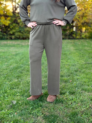 Front view of olive green wide-leg pants with an elastic waistband and matching long-sleeve top.