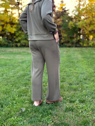 Back view of an olive green matching set with relaxed wide-leg pants and a banded-hem top.