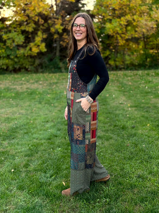 A lady wearing a knit patchwork overall.