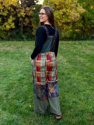 A lady wearing a knit patchwork overall.