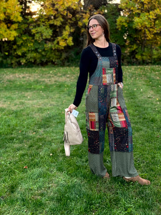 A lady wearing a knit patchwork overall.