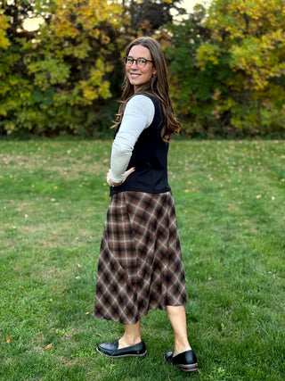 Shop our diagonal plaid A-line maxi skirt. Perfect for fall, this high-waisted brown skirt offers a flattering fit and timeless style. Elevate your look now!