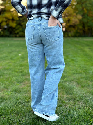 Elevate your denim collection with these KanCan wide-leg jeans featuring a unique boho-inspired whip stitch side detail. The flattering high-rise silhouette and vintage light wash deliver effortless style and premium comfort for any occasion.