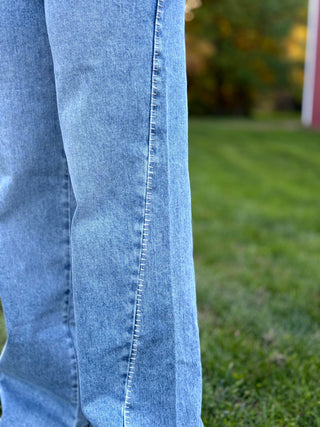 Elevate your denim collection with these KanCan wide-leg jeans featuring a unique boho-inspired whip stitch side detail. The flattering high-rise silhouette and vintage light wash deliver effortless style and premium comfort for any occasion.