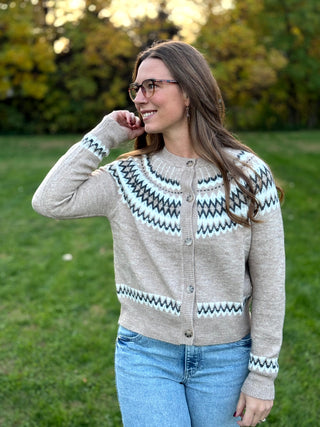 Embrace seasonal charm with this timeless Nordic-inspired snap cardigan. Crafted for cozy warmth, its intricate Fair Isle pattern and easy-front closure make it the ultimate effortless layer for chilly days.