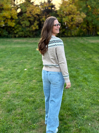 Embrace seasonal charm with this timeless Nordic-inspired snap cardigan. Crafted for cozy warmth, its intricate Fair Isle pattern and easy-front closure make it the ultimate effortless layer for chilly days.
