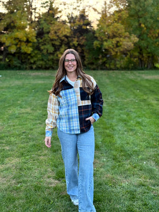 Upgrade your wardrobe with this oversized mixed media plaid shacket. Featuring a unique patchwork design, it's the ultimate cozy statement piece. Shop today!