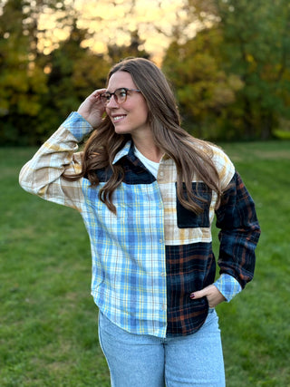 Upgrade your wardrobe with this oversized mixed media plaid shacket. Featuring a unique patchwork design, it's the ultimate cozy statement piece. Shop today!