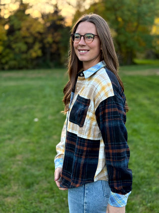 Upgrade your wardrobe with this oversized mixed media plaid shacket. Featuring a unique patchwork design, it's the ultimate cozy statement piece. Shop today!