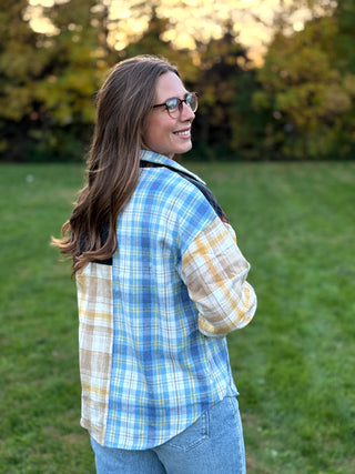 Upgrade your wardrobe with this oversized mixed media plaid shacket. Featuring a unique patchwork design, it's the ultimate cozy statement piece. Shop today!