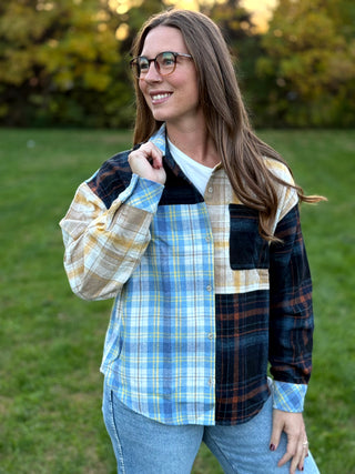 Upgrade your wardrobe with this oversized mixed media plaid shacket. Featuring a unique patchwork design, it's the ultimate cozy statement piece. Shop today!