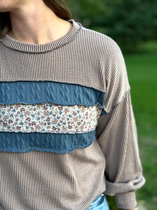 Elevate your everyday style with this cozy waffle-textured top featuring charming floral stripes and chic denim-blue accents. Its relaxed drop-shoulder fit and feminine details offer effortless comfort for seamless seasonal layering.