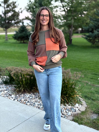 Elevate your seasonal style with this rich, earth-toned patchwork knit featuring a premium waffle texture. This breathable long-sleeve top balances effortless comfort with a bold, modern aesthetic for a versatile look that transitions from coffee dates to cozy evenings. Stay warm without the bulk in this must-have autumn staple.