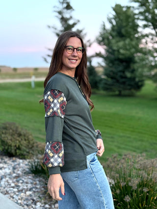 Elevate your everyday style with this uniquely crafted olive Henley featuring eye-catching plaid patchwork sleeves. Its ultra-soft fabric and relaxed fit provide the perfect blend of rustic charm and modern comfort.