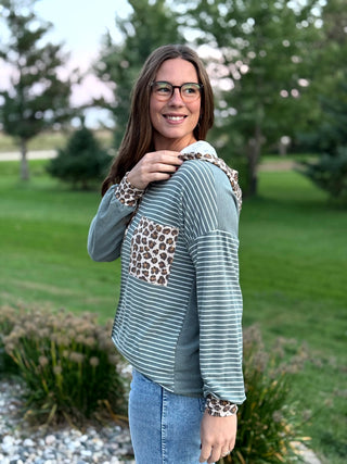 Shop our Sage & Wild Leopard Mixed Media Hoodie. Featuring stripes, animal print accents, and a button neckline, it's the perfect cozy everyday top for women.