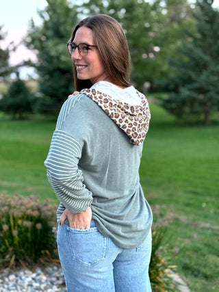 Shop our Sage & Wild Leopard Mixed Media Hoodie. Featuring stripes, animal print accents, and a button neckline, it's the perfect cozy everyday top for women.