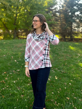 Full-length view of a model wearing the pink plaid cowl-neck top with three-quarter sleeves and dark jeans.