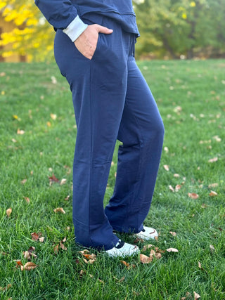 Side view of navy wide-leg pants showing the front pocket and relaxed fit