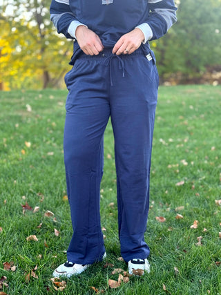 Front view of navy wide-leg drawstring pants with an elastic waistband and side pockets
