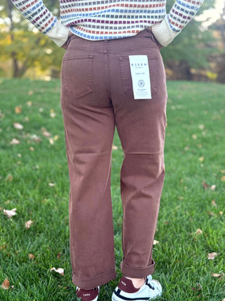 Back view of brown jeans showing two patch pockets, belt loops, and rolled cuffs.