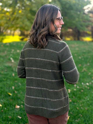 Close-up back view of a dark olive striped knit cardigan with long sleeves and a ribbed hem.