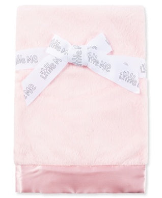 Pink towel with a white label on a white background