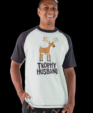 Man wearing a t-shirt with a deer graphic and 'Trophy Husband' text on a black background