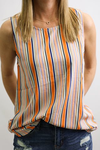 Multicolored striped tank top worn by a person on a plain background
