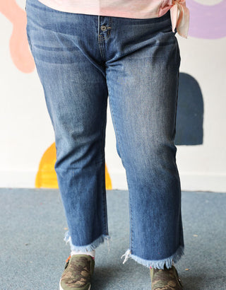 Person wearing blue jeans with a blurred background