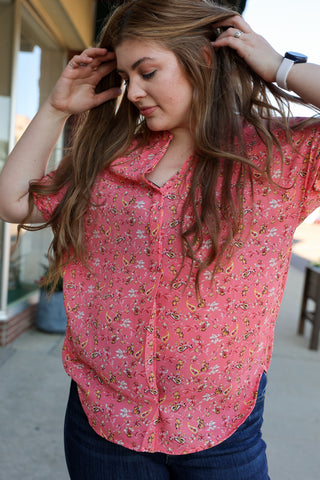 Woman wearing a pink floral blouse outdoors