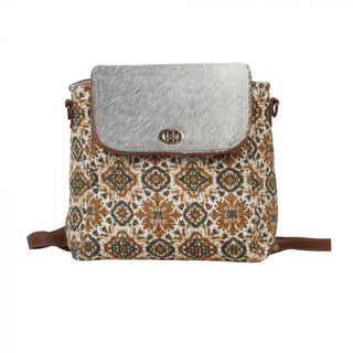 Patterned bag with a textured flap on a white background