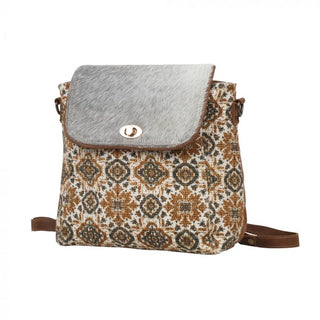 Patterned bag with a textured flap on a white background
