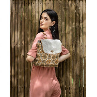 Patterned bag with a textured flap on a white background