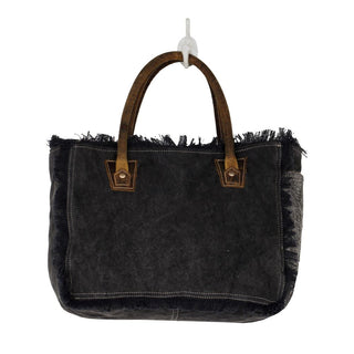Handbag with patterned fabric and brown leather accents on a white background