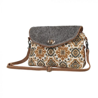 Flap-over handbag with patterned front and gray top, on a white background